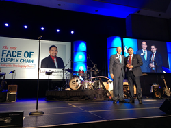 George Prest, CEO of MHI, (left) presents Luis Castaneda (right) with the 2016 Face of the Supply Chain award.