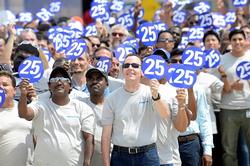 Mitsubishi Caterpillar Forklift America Inc. (MCFA) commemorates its 25th year of producing and distributing quality material handling products in North, Central and South America. Above, MCFA President Ken Barina joins the celebration with some of the nearly 1,200 employees.