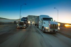 Trucks haul cargo over the Gerald Desmond Bridge in the Port of Long Beach.