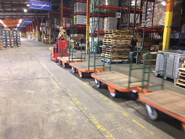 : The trailers are utilized behind electric tow tractors with multiple units used to increase picking rates.