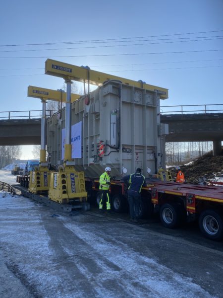 A hydraulic gantry was used to lower the transformer onto skidding equipment.