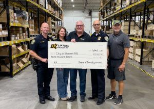 Steve and Jane Napieralski, of OZ Lifting Products, present Chief Pizzano and Lt. Grimes from the Pleasant Hill Police Department with a $12,000 donation for the acquisition and training of a specially imported K9. Trace Erickson, of Code Blue K9, is far right. This dog will be trained in the 2026 course.