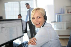 Lady with headphones working at a computer image
