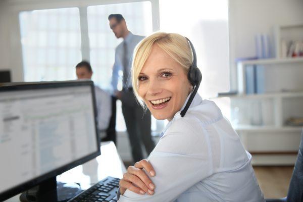 Lady with headphones working at a computer image